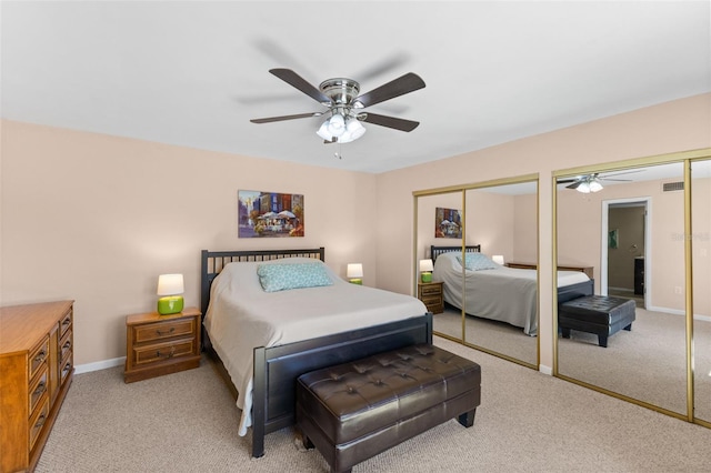 14519 Catalina Cir, Seminole, FL 33776 - bedroom featuring two closets, baseboards, and carpet