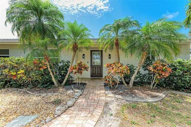 property entrance with stucco siding