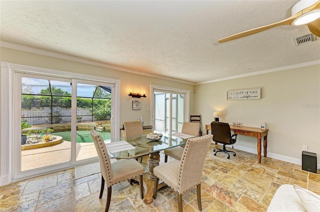 dining room featuring crown molding, a textured ceiling, stone tile floors, baseboards, and visible vents