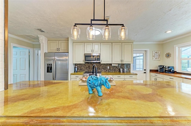 kitchen featuring light stone countertops, visible vents, and appliances with stainless steel finishes