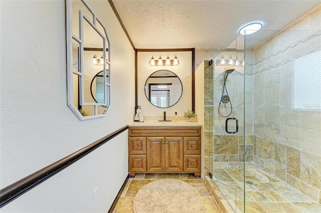 full bathroom with a textured ceiling, a stall shower, stone tile floors, vanity, and baseboards