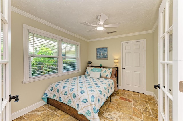 bedroom featuring stone tile floors, visible vents, french doors, crown molding, and baseboards