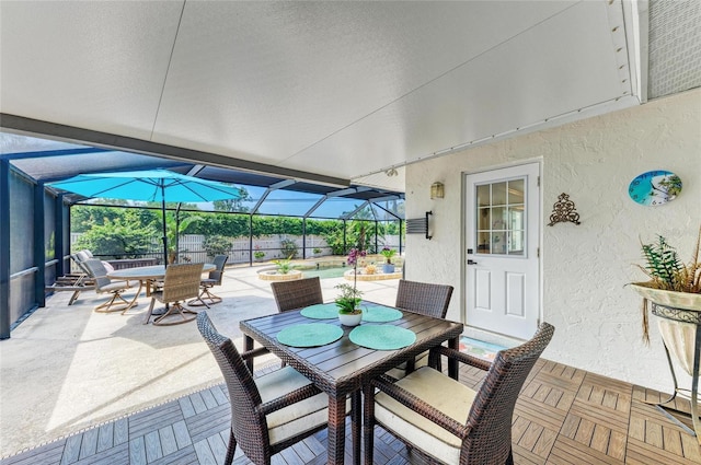 view of patio / terrace with glass enclosure and outdoor dining space
