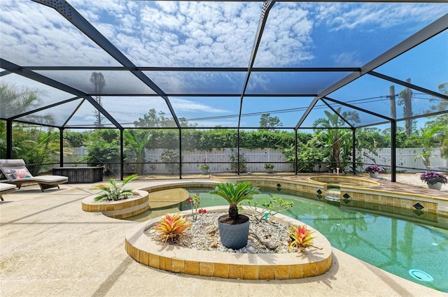exterior space featuring a fenced backyard, a lanai, a patio, and a pool with connected hot tub