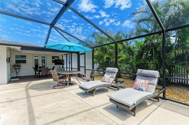 view of patio / terrace featuring a lanai, french doors, and outdoor dining space