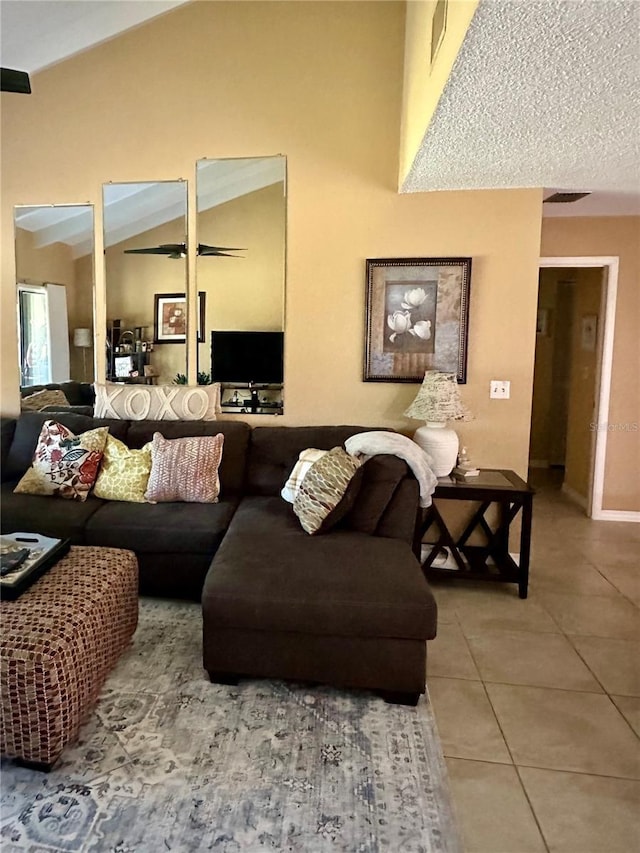living room with vaulted ceiling and tile patterned floors