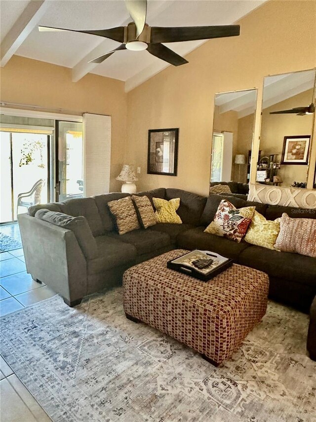 tiled living area featuring ceiling fan and lofted ceiling with beams