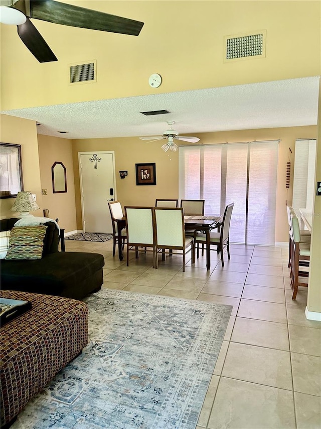 living room with visible vents, ceiling fan, and light tile patterned flooring