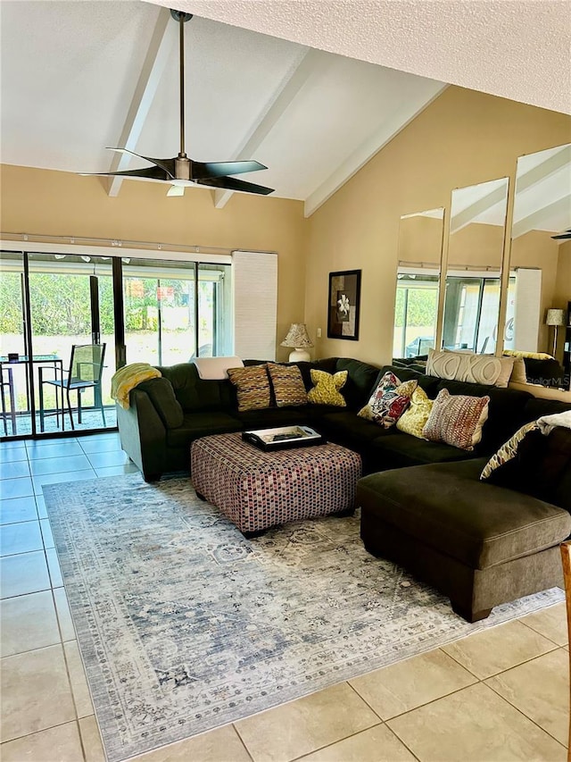 tiled living room featuring a wealth of natural light, ceiling fan, and high vaulted ceiling