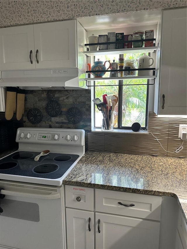 kitchen featuring white range with electric cooktop, under cabinet range hood, backsplash, and white cabinetry