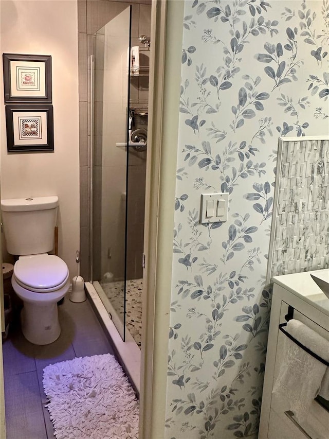 full bath featuring vanity, a shower stall, and toilet