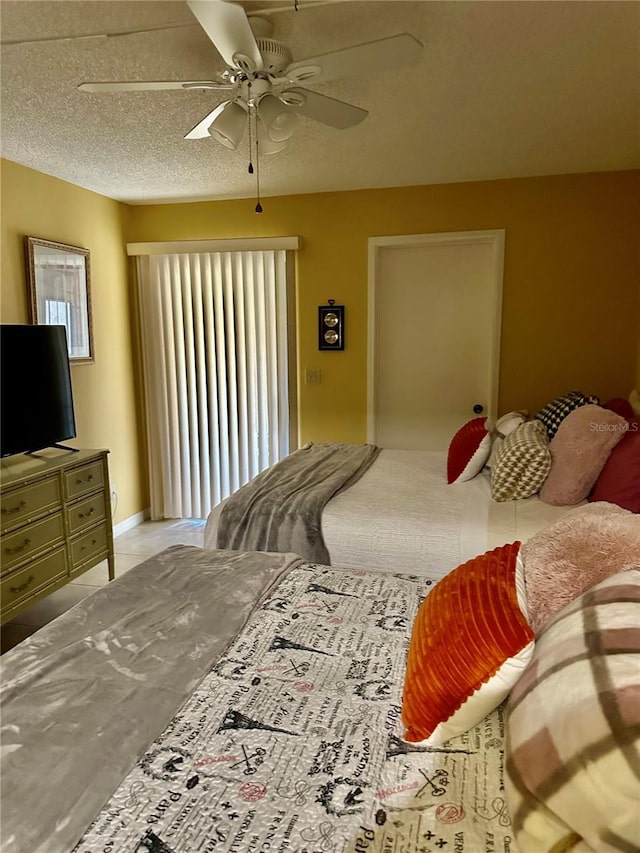 bedroom featuring a textured ceiling and ceiling fan