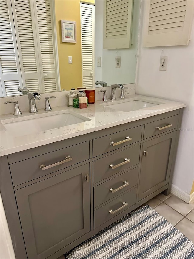 bathroom featuring double vanity, tile patterned flooring, and a sink