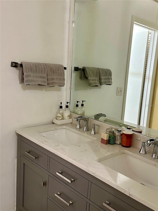 full bathroom featuring a sink and double vanity
