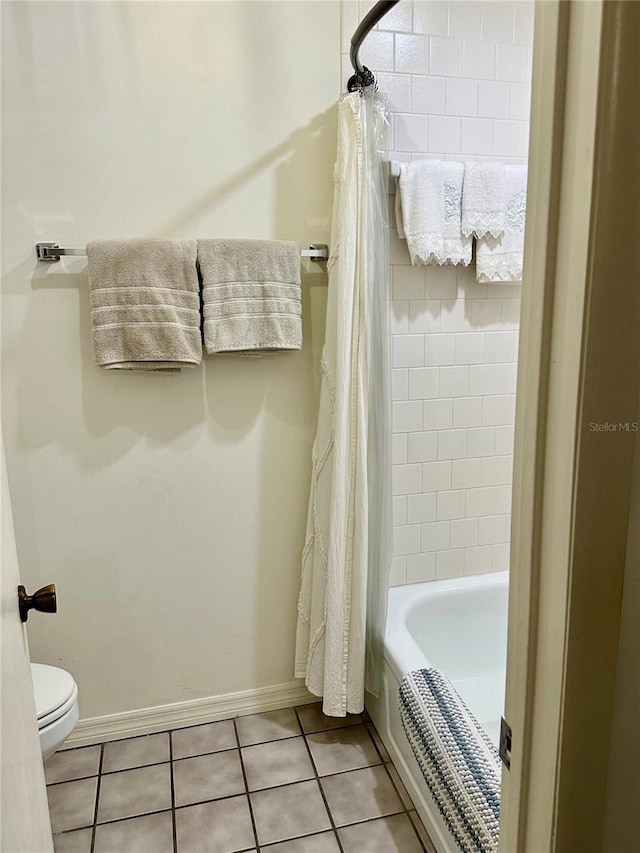 bathroom with shower / bath combo, toilet, and tile patterned flooring