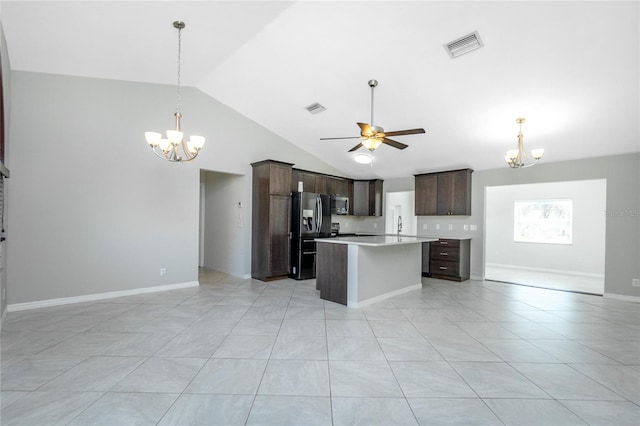 kitchen with dark brown cabinetry, lofted ceiling, open floor plan, and refrigerator with ice dispenser