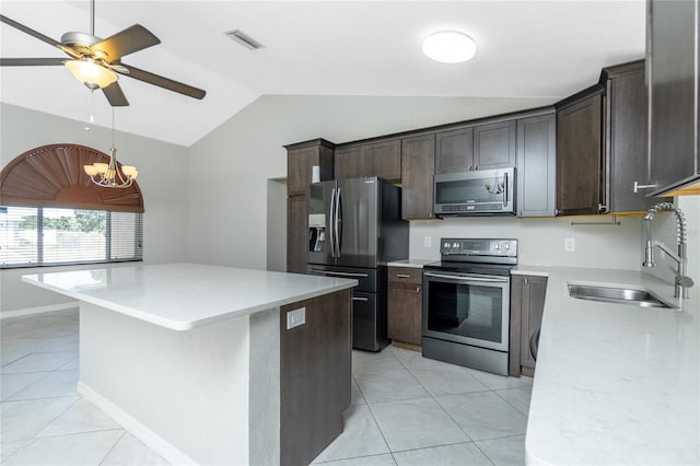 kitchen featuring a sink, visible vents, dark brown cabinetry, lofted ceiling, and appliances with stainless steel finishes