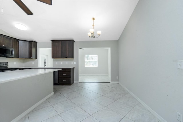 kitchen featuring dark brown cabinets, stainless steel microwave, electric stove, and light countertops