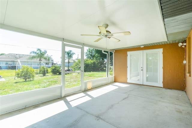 unfurnished sunroom with french doors and a ceiling fan