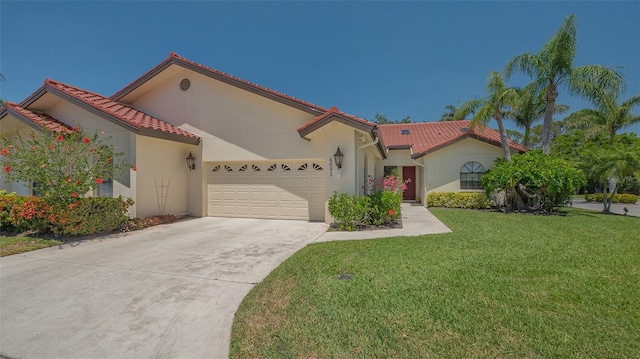 4691 Las Brisas Ln, Sarasota, FL 34238 - mediterranean / spanish-style house with concrete driveway, an attached garage, a front lawn, and stucco siding