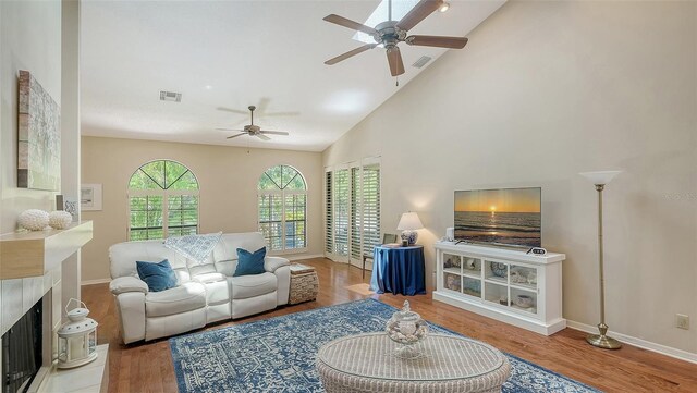 4691 Las Brisas Ln, Sarasota, FL 34238 - living area with ceiling fan, visible vents, wood finished floors, baseboards, and high vaulted ceiling