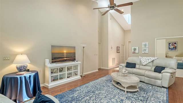 4691 Las Brisas Ln, Sarasota, FL 34238 - living room featuring visible vents, wood finished floors, high vaulted ceiling, a ceiling fan, and a skylight
