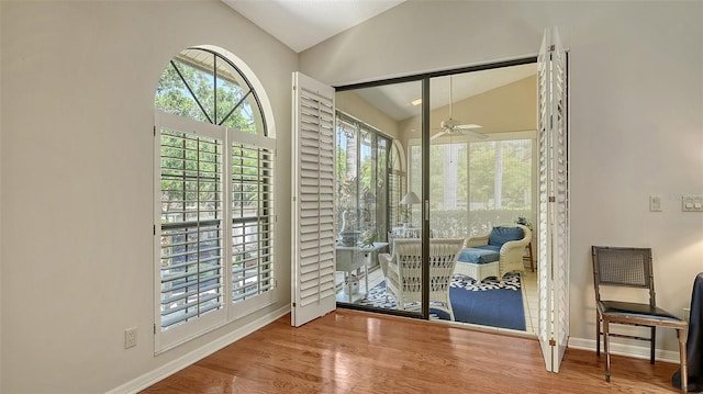 4691 Las Brisas Ln, Sarasota, FL 34238 - doorway with a ceiling fan, baseboards, vaulted ceiling, and wood finished floors