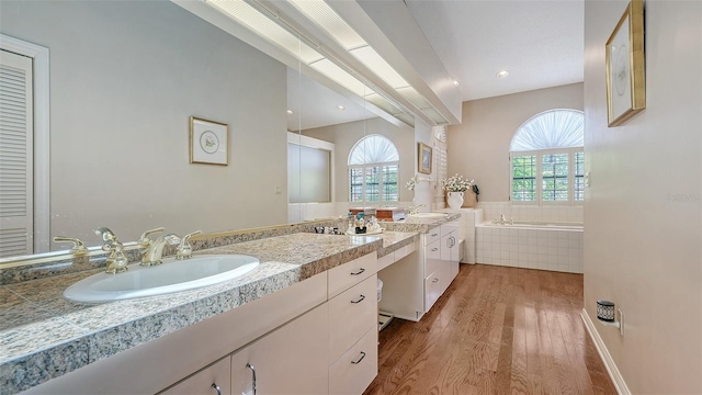 4691 Las Brisas Ln, Sarasota, FL 34238 - full bathroom with double vanity, a wealth of natural light, a sink, and wood finished floors