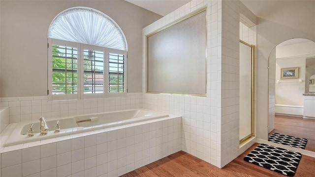 4691 Las Brisas Ln, Sarasota, FL 34238 - bathroom featuring a shower stall, wood finished floors, and a garden tub