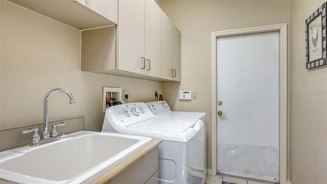 4691 Las Brisas Ln, Sarasota, FL 34238 - clothes washing area with cabinet space, washing machine and dryer, and a sink
