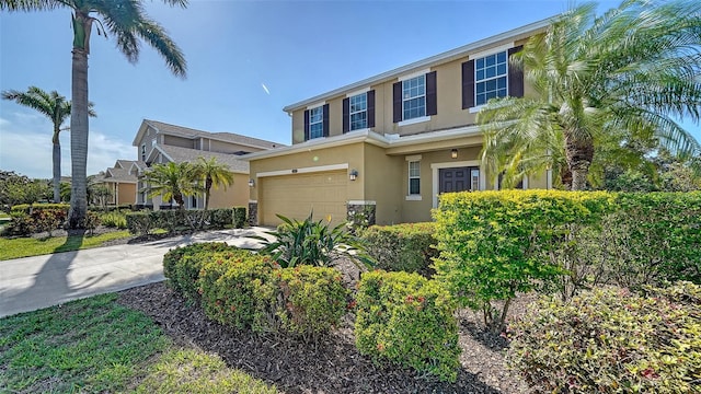 5403 Mang Pl, Sarasota, FL 34238 - view of front of home with concrete driveway, an attached garage, and stucco siding