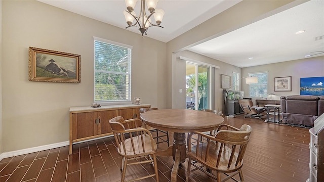 5403 Mang Pl, Sarasota, FL 34238 - dining space with an inviting chandelier, baseboards, plenty of natural light, and dark wood-style floors