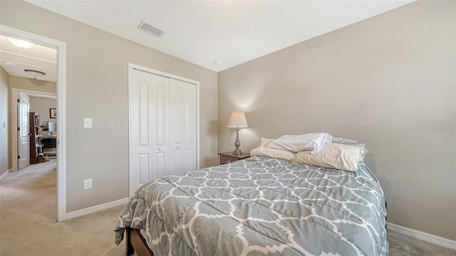 5403 Mang Pl, Sarasota, FL 34238 - bedroom featuring visible vents, baseboards, a closet, and light colored carpet