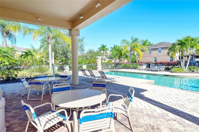 5403 Mang Pl, Sarasota, FL 34238 - community pool featuring a patio, fence, and outdoor dining space