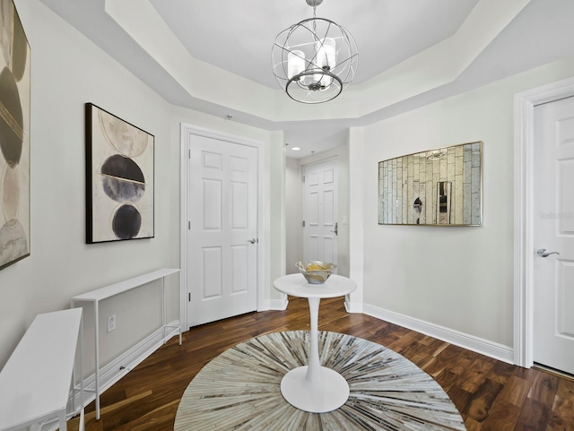 1771 Ringling Blvd Unit 1104, Sarasota, FL 34236 - hallway with baseboards, a chandelier, wood finished floors, and a raised ceiling