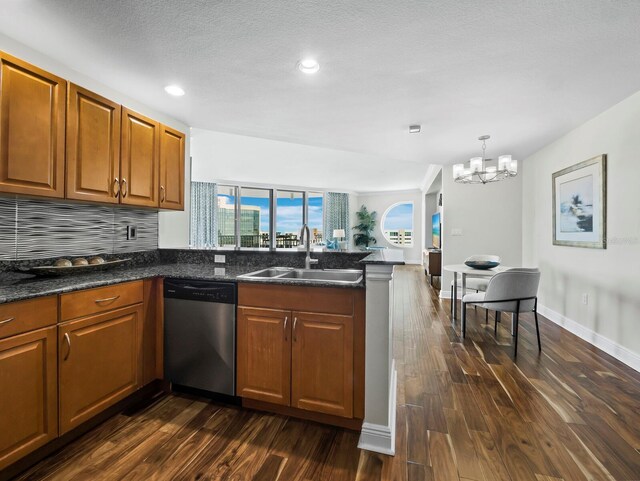 1771 Ringling Blvd Unit 1104, Sarasota, FL 34236 - kitchen with a notable chandelier, a sink, dishwasher, a peninsula, and dark wood-style floors