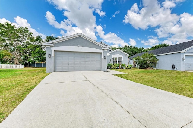 ranch-style home featuring a front lawn, concrete driveway, an attached garage, and stucco siding