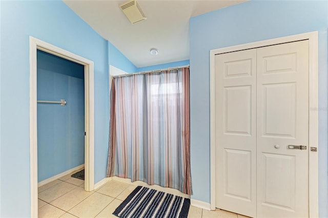 full bath featuring tile patterned floors and baseboards
