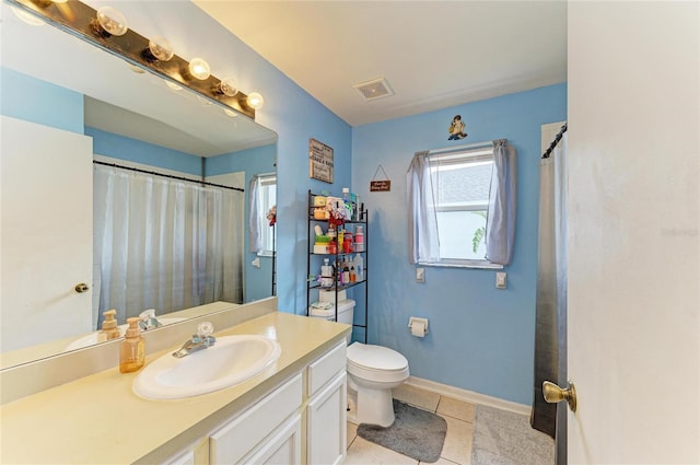 full bathroom with toilet, vanity, tile patterned floors, and a shower with curtain