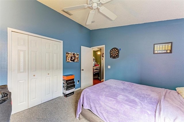 bedroom featuring vaulted ceiling, carpet, a closet, and ceiling fan