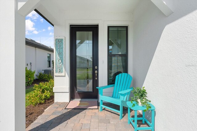 entrance to property with stucco siding
