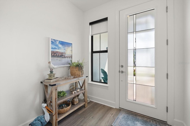 entryway featuring wood finished floors and baseboards