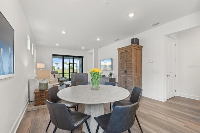 dining area with wood finished floors, recessed lighting, and baseboards