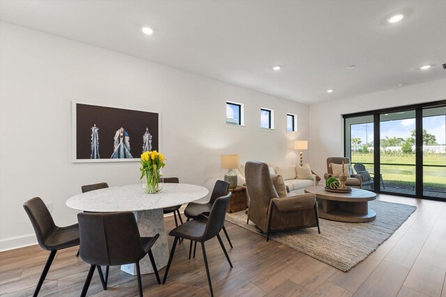 dining space with light wood-type flooring and recessed lighting