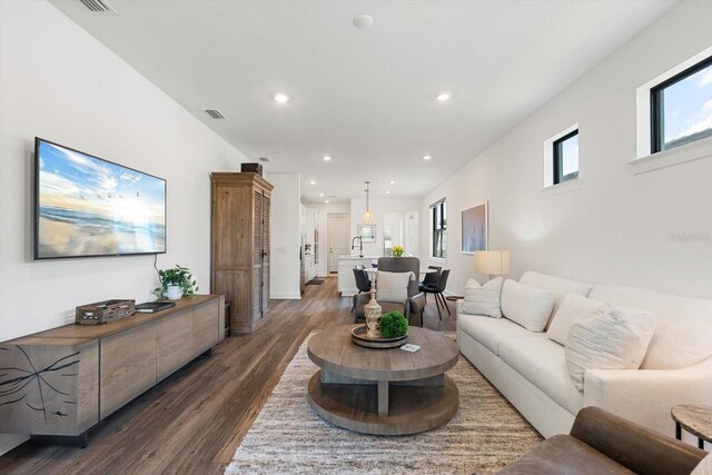 living room featuring dark wood-style flooring and recessed lighting