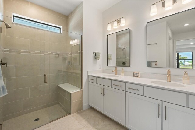 bathroom with a stall shower, double vanity, and recessed lighting