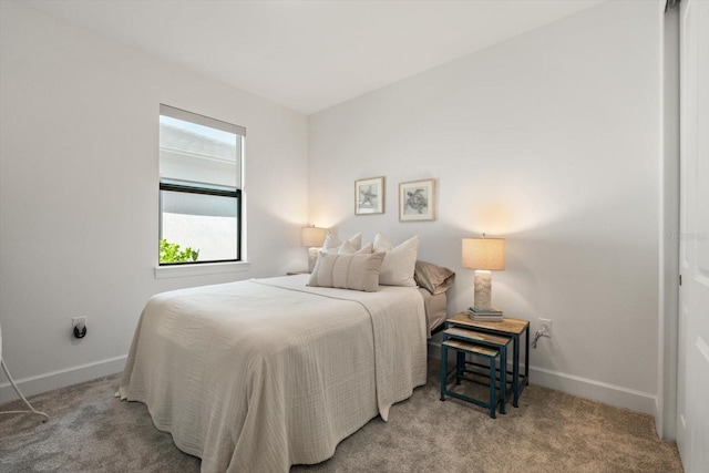 carpeted bedroom featuring baseboards