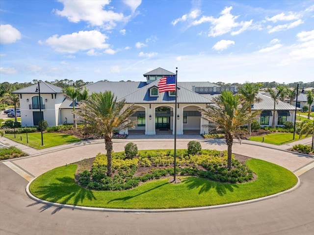 view of building exterior with curved driveway and a residential view