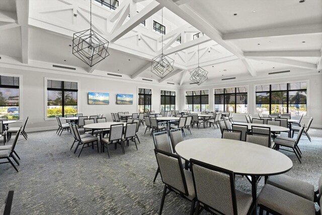 dining area featuring carpet, baseboards, beam ceiling, coffered ceiling, and a towering ceiling