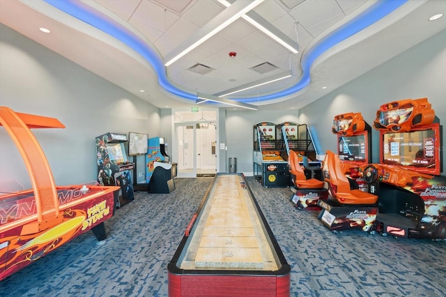 rec room featuring carpet flooring, a tray ceiling, and recessed lighting